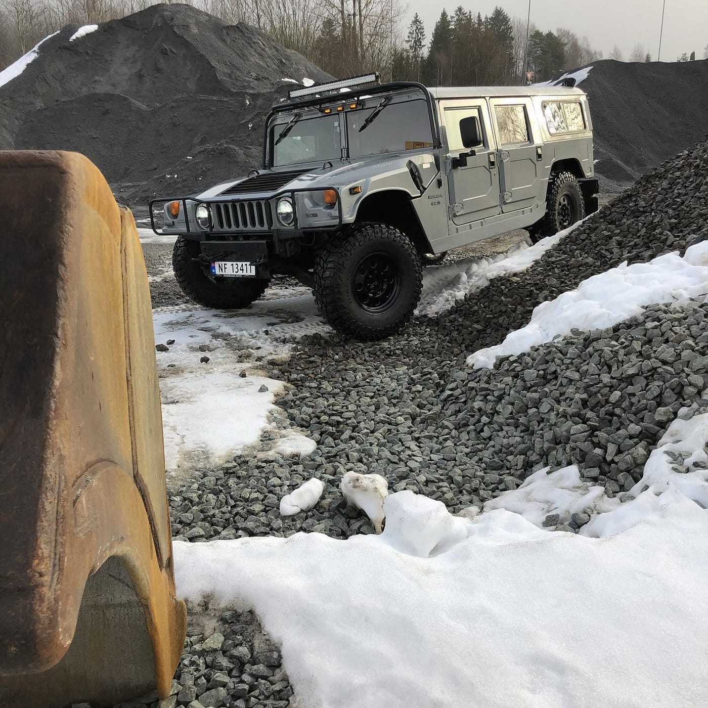 Hummer H1 på en grusplass med snø